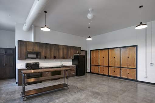 A kitchen with wooden cabinets and a stainless steel island.