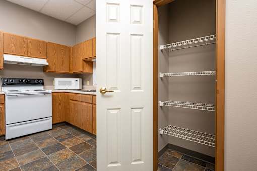 A kitchen with a white door and a white oven.