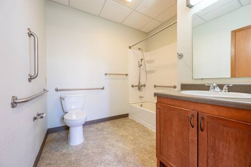 A bathroom with a toilet, sink, and bathtub.