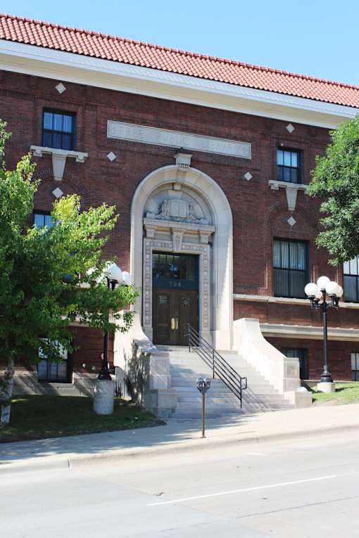 A red brick building with a large arched entrance.