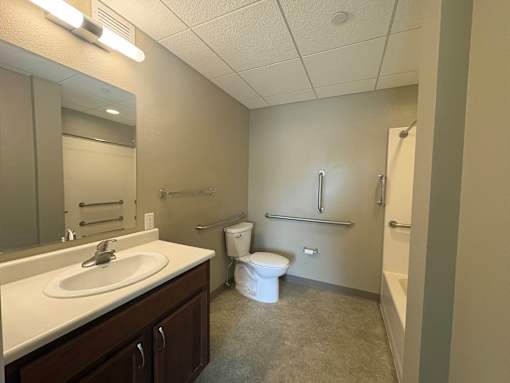 A bathroom with a toilet, sink, and bathtub.