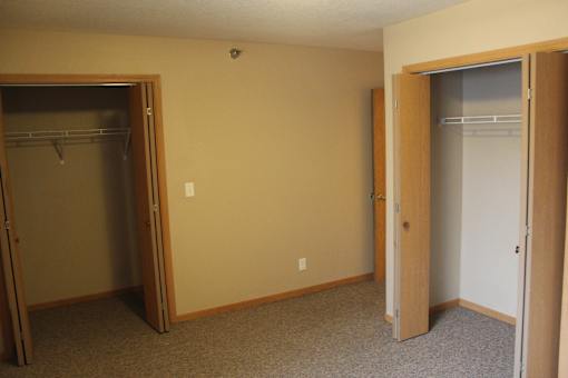 A room with a closet and a door.