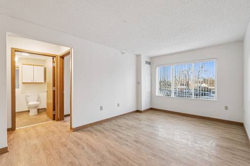 A room with a toilet visible through an open door.