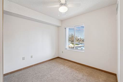 Empty room with a window showing an outdoor view.