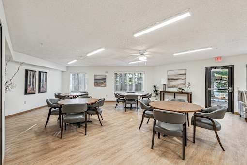A room with a long table and chairs.