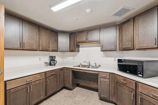A kitchen with wooden cabinets and a white countertop.