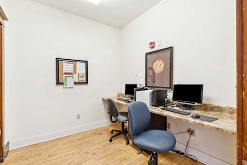 A room with a desk and a chair.