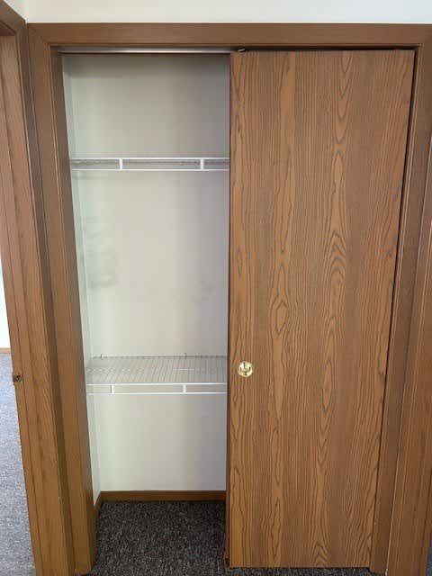 A wooden door with a glass panel and a handle.