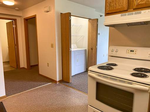 A white stove in a kitchen with a white oven.