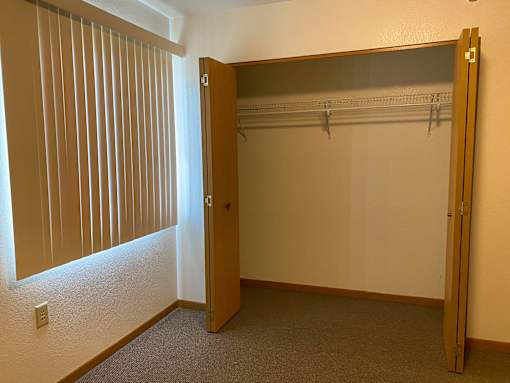 A room with a closet and a door.