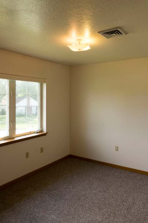 A room with a window and a ceiling light.