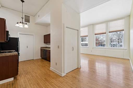 A kitchen with wooden floors and white walls.