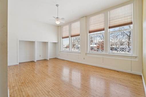 Empty room with wooden floors and white walls.