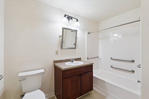 A white toilet sits next to a sink in a small bathroom.