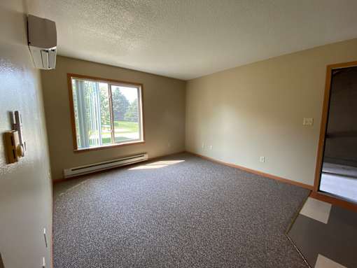 A room with a window and a door.