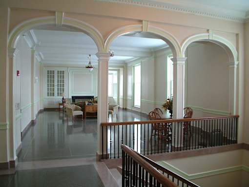 A large open room with arches and a balcony.