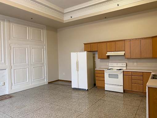 A kitchen with a white refrigerator and a white stove top oven.