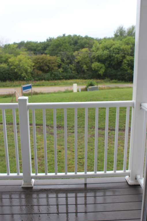 A white railing with a sign on top of it.