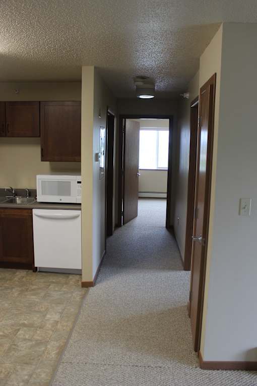 A small kitchen with a microwave, oven, and sink.