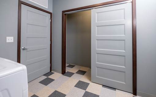 A white door is open to a hallway.