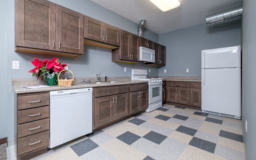A kitchen with brown cabinets and a checkered floor.