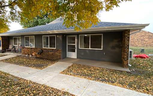 A house with a grey roof and a grey garage door.