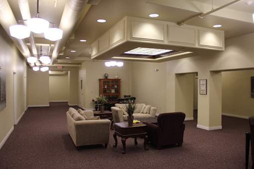 A living room with a couch, chairs, and a coffee table.