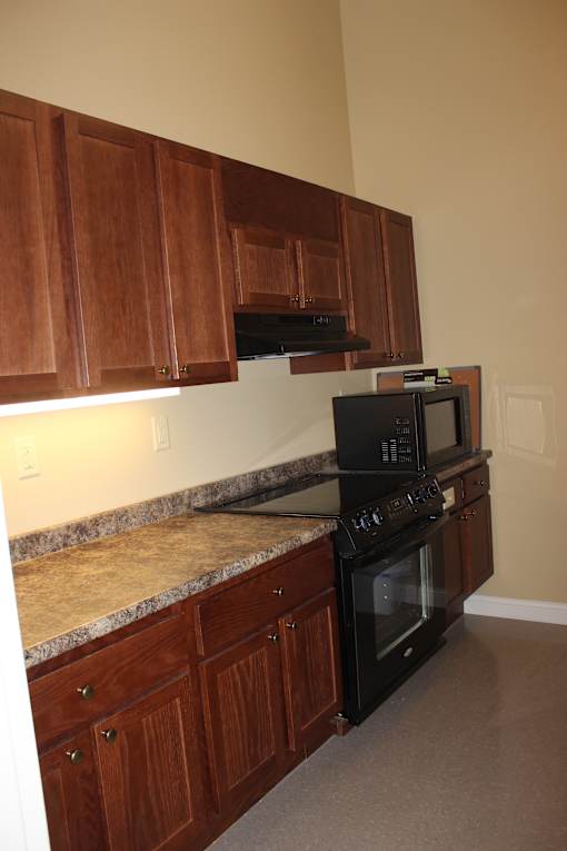 A kitchen with a staircase leading to the upper floor.