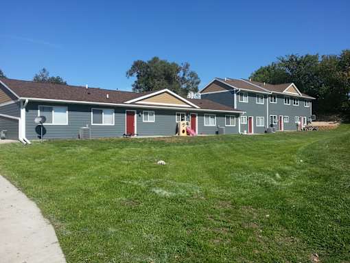 A row of houses with a clear blue sky above them.