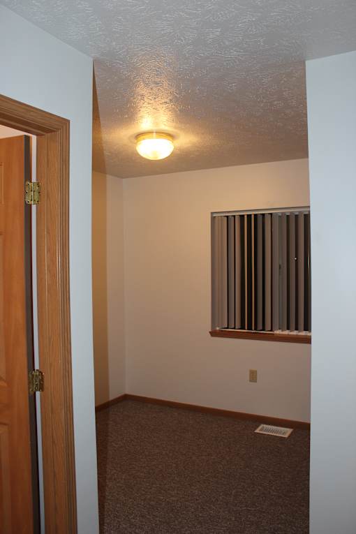 A white wall with a light on it.