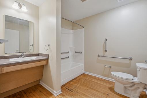 A bathroom with a sink, toilet, and bathtub.