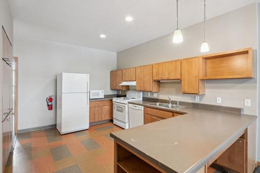 A kitchen with a white refrigerator, white oven, and wooden cabinets.