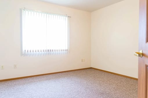 A room with a window and a door.
