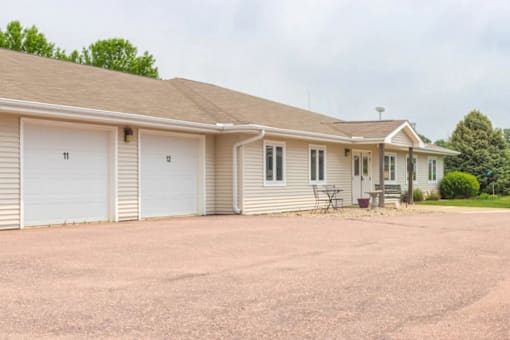 A two-story house with a garage and a driveway.