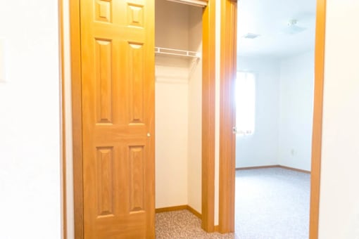 A white room with a wooden door.