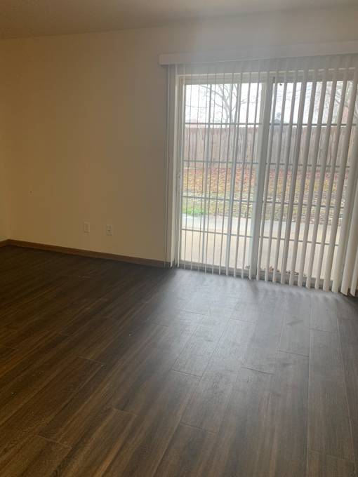 A window with blinds is open, letting in light.