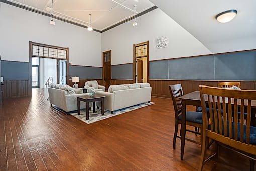 A living room with a white couch and a wooden table.
