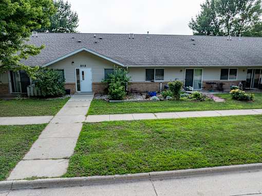 A house with a white door and a small front yard.
