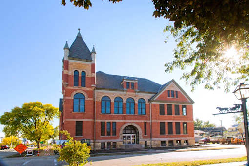 Roosevelt School is a two story brick building with large historic windows and a tower in the northeast corner of the building.
