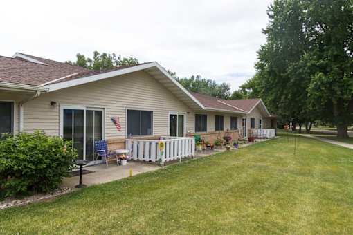A house with a white fence and a flag on the front porch.