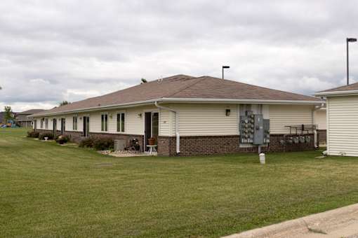 A house with a brown roof and a white garage door.