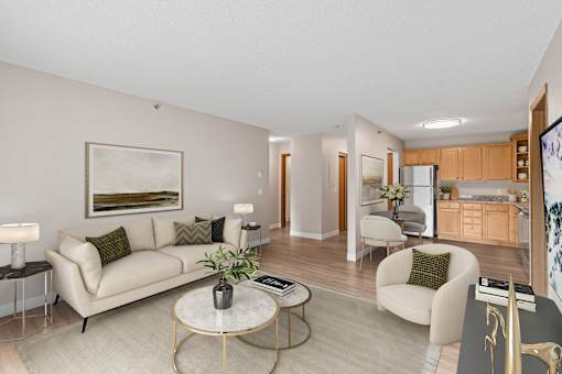 Living room, dining area, and kitchen in a newly renovated apartment home at Park Pointe Apartments in St. Louis Park, MN 55426