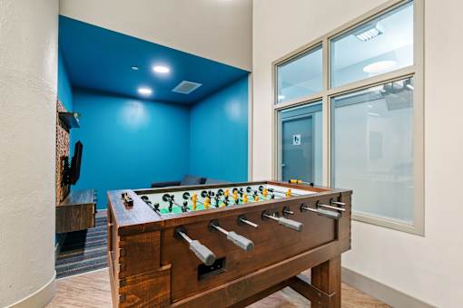 Game room with billiards, foosball, lounge chairs, darts, and TVs at The Cosmopolitan, St Paul, 55101