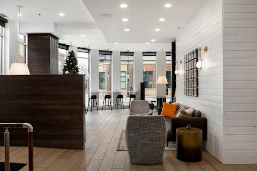 A reception area with a wooden desk and a chair.