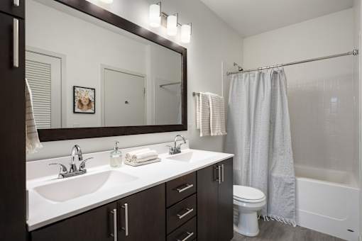 A bathroom with a white sink and a white toilet.