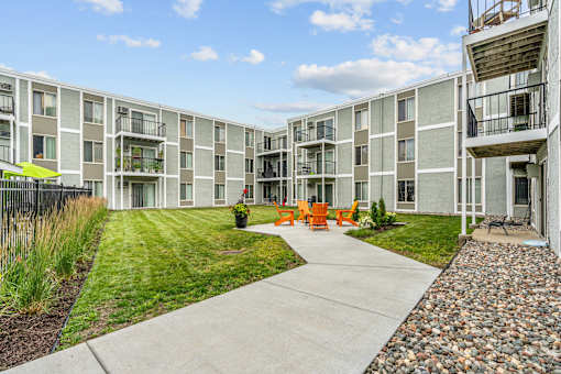 Courtyard with lounge chairs and fire pits at Lou Park, St. Louis Park, MN, 55426