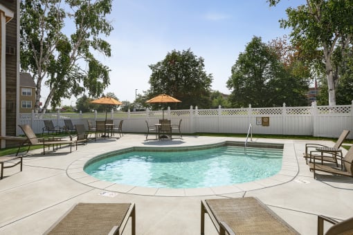Outdoor swimming pool with lounge area at Mallard Creek, Minnesota, 55427