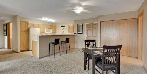 A dining room with a table set for two.
