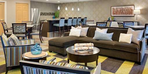 A living room with a brown couch and a coffee table.