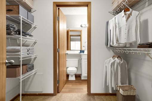 a small bathroom with a toilet and walk in closet